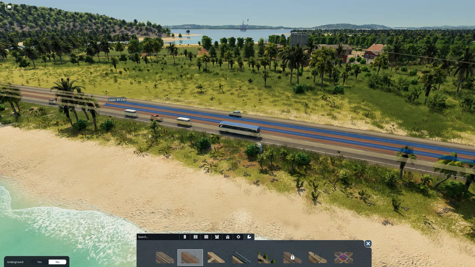 The Transport Fever 3 bus lane tool in use on a road along a tropical beach, with buses and cars, the cost next to the cursor and the street tools bar at the bottom