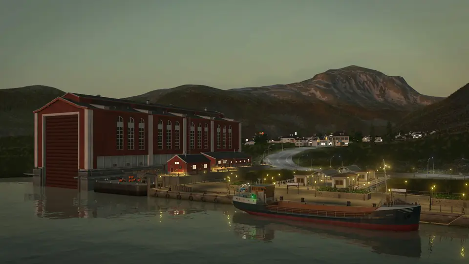 A red industrial hall and a small cargo ship at a quay on a fjord at dusk, with village lights on the hillside, in Transport Fever 3, from the campaign's fifth mission