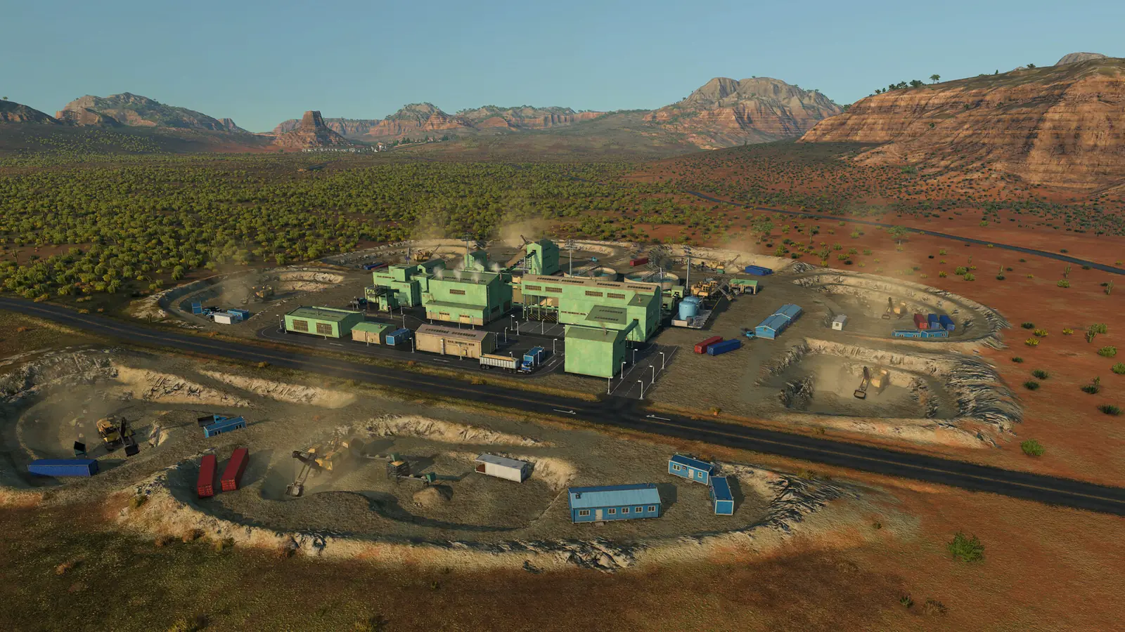 A Transport Fever 3 mine in a red desert seen from above: green factory buildings beside a road, ringed by open pits with excavators and shipping containers