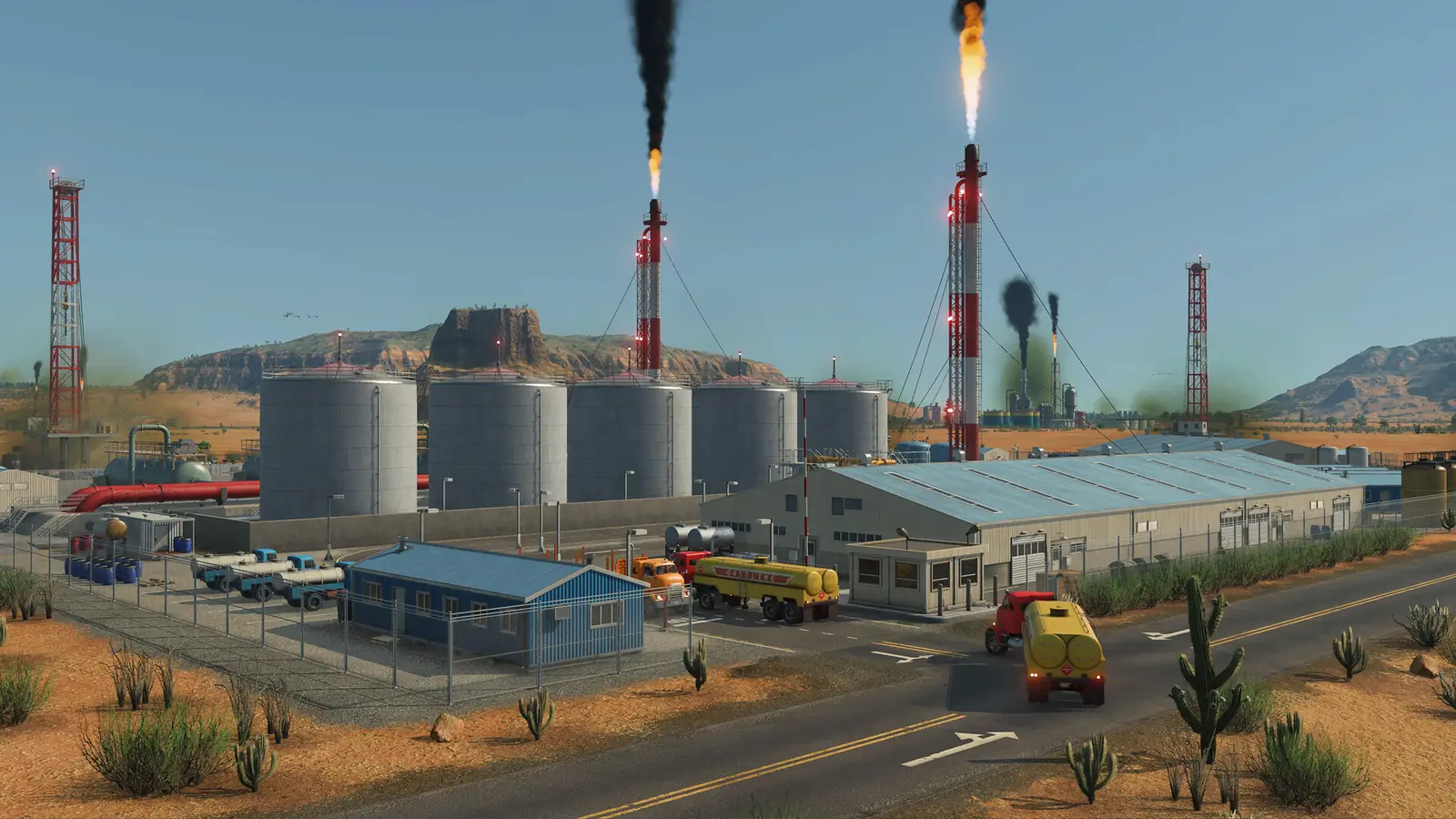 A Transport Fever 3 oil refinery in the desert: a row of grey storage tanks, red and white flare stacks and yellow tanker trucks on the road outside