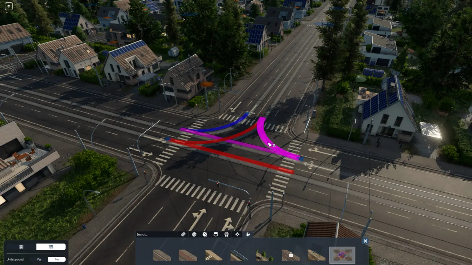 The Transport Fever 3 lane management tool at a busy junction, with colored arrows showing which lane leads to which and suburban houses with solar panels around it
