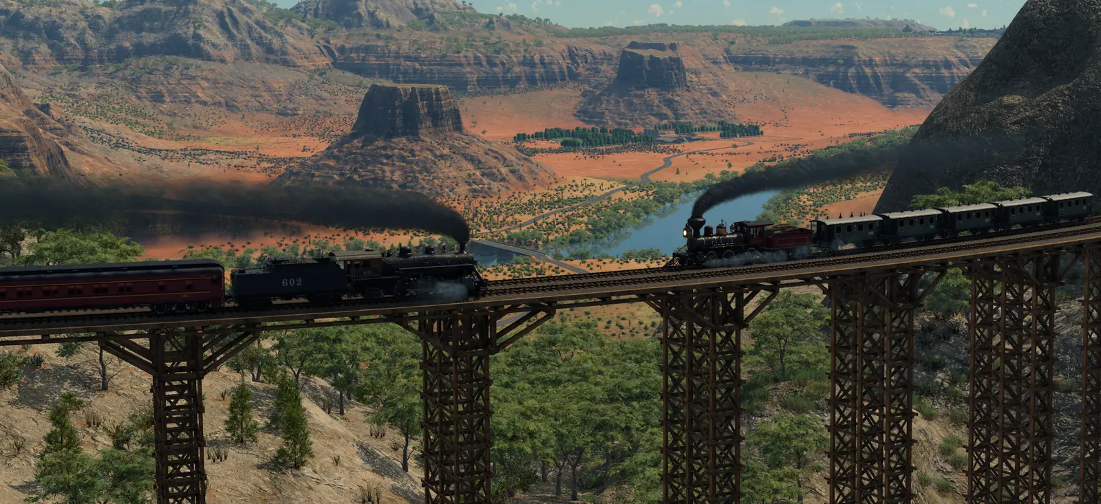 Two steam trains pulling passenger coaches across a tall steel trestle bridge above a dry valley with mesas and a river in Transport Fever 3
