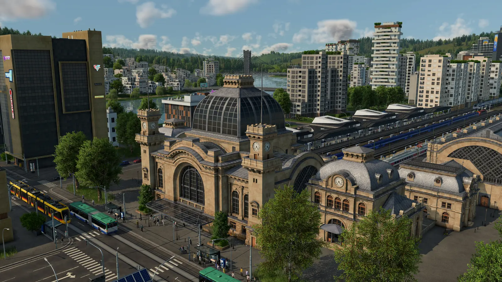 A Transport Fever 3 city with a large domed train station, trams and buses in the street in front of it, and apartment towers by a river behind