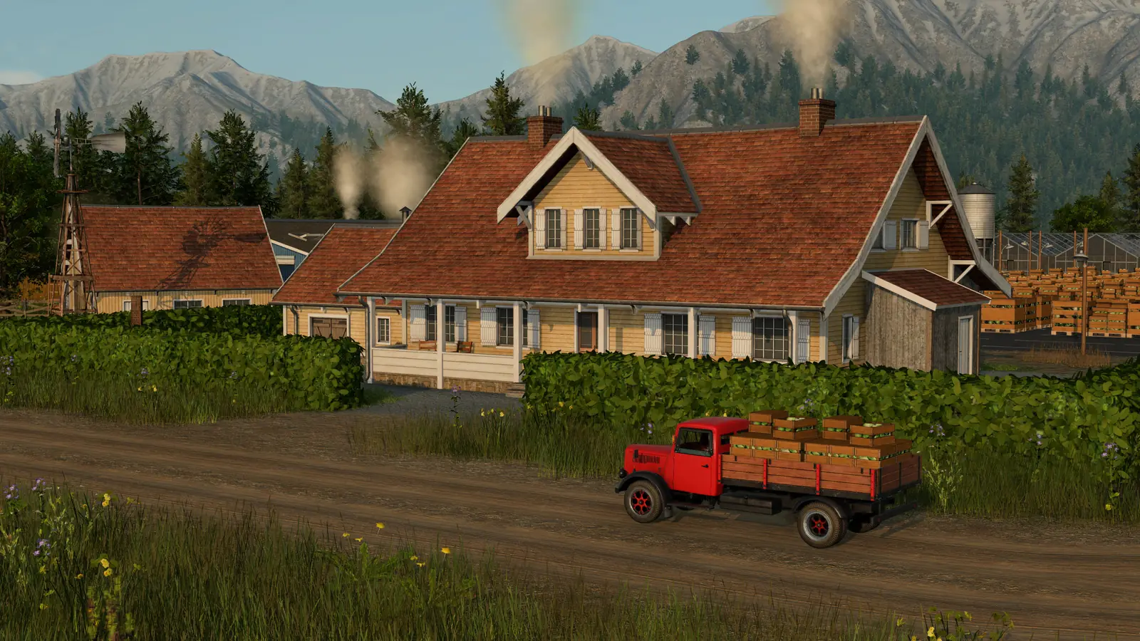 A red early truck loaded with crates of vegetables on a dirt road past a farmhouse in Transport Fever 3, with greenhouses and mountains behind